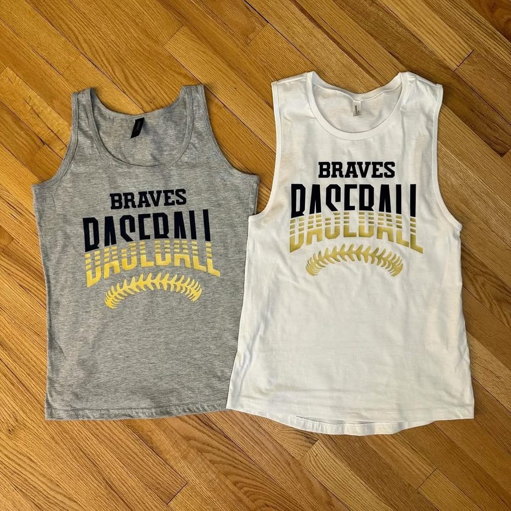 Gray and white “Braves Baseball” tank tops with gold baseball-stitch graphics